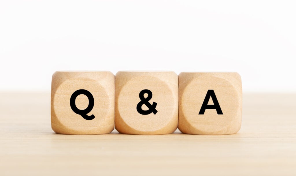 Q&A or questions and answers concept. Wooden blocks with text on desk. Copy space