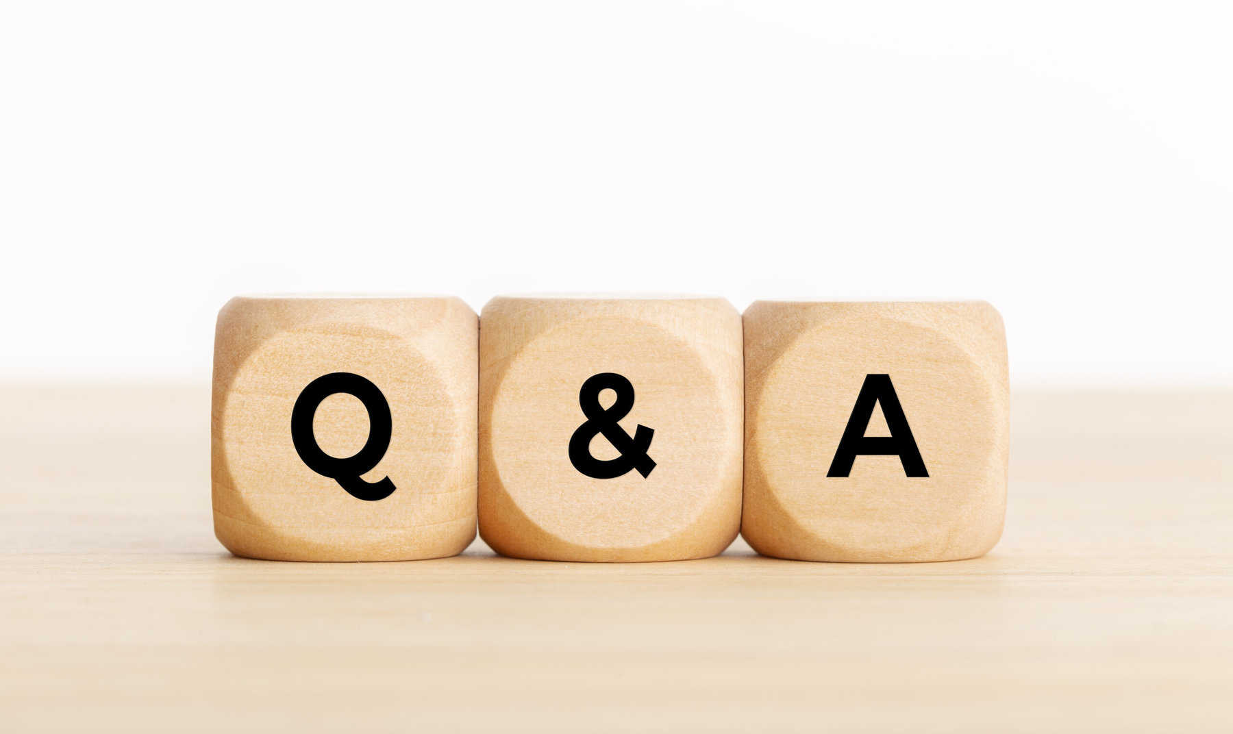 Q&amp;A or questions and answers concept. Wooden blocks with text on desk. Copy space